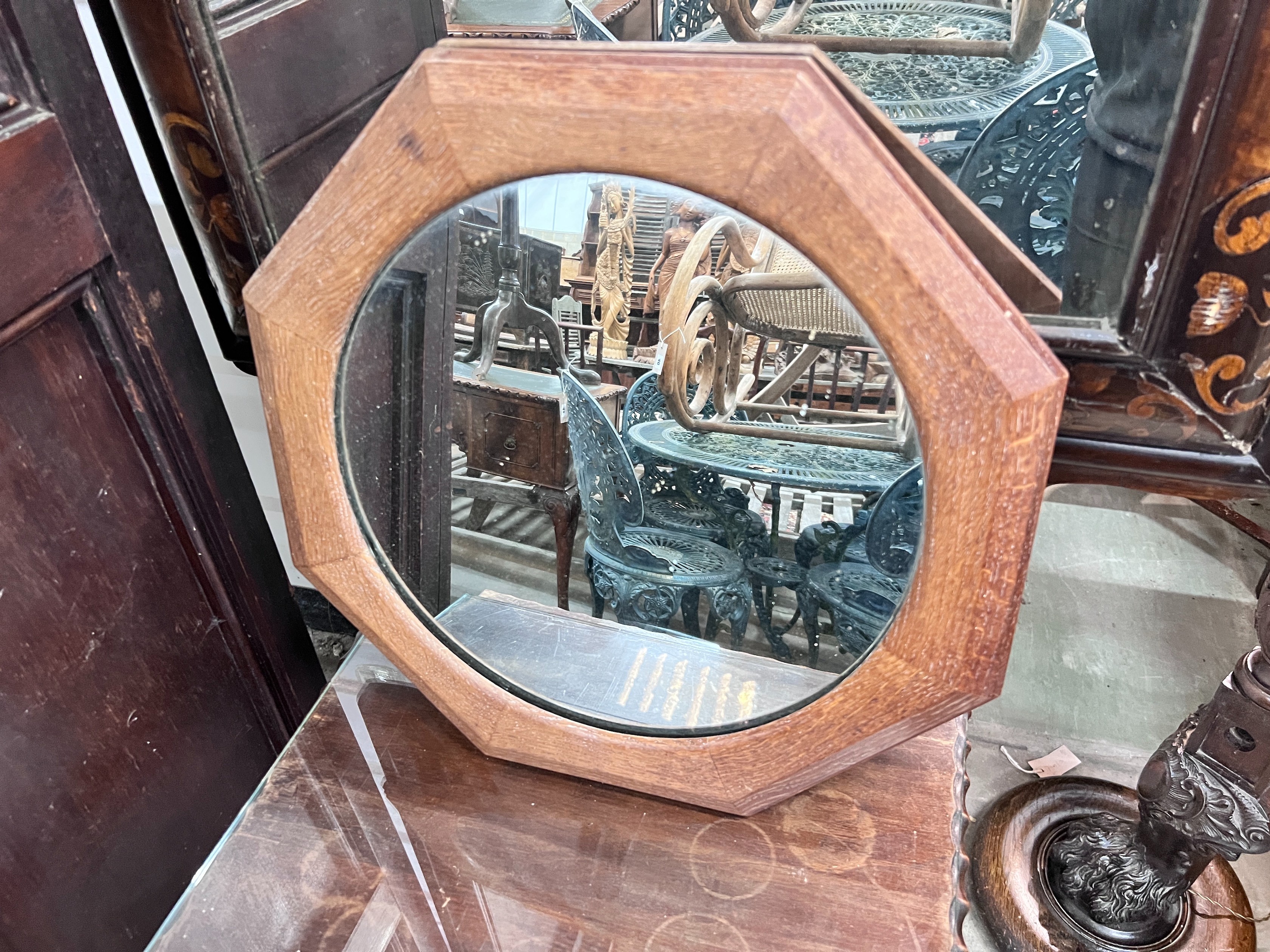 A 1920's mahogany side table, width 45cm, height 70cm, together with an octagonal oak framed wall mirror *Please note the sale commences at 9am.